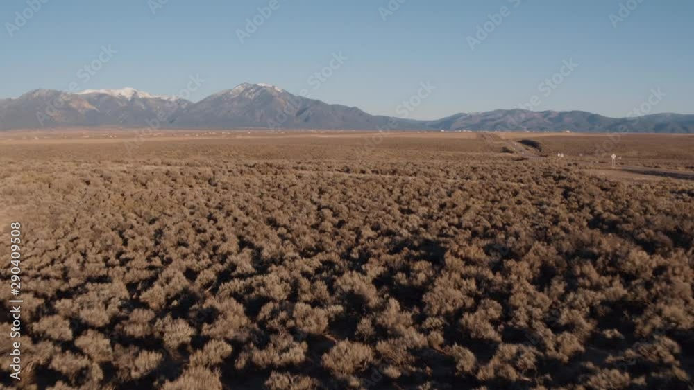 Scenic view flying over fields of shrub toward mountains Scenic view flying over fields of shrub toward mountains
