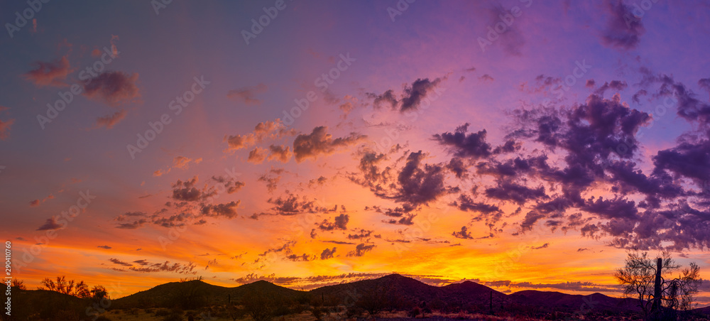 Naklejka premium Sunrise panorama over the sonoran desert of Arizona with layers of mountains shot at altitude by a drone.