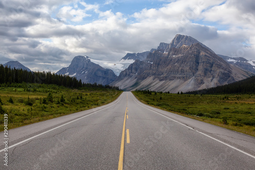 Scenic road in the Canadian Rockies during a vibrant sunny and cloudy summer morning. Taken in Icefields Parkway, Banff National Park, Alberta, Canada. © edb3_16