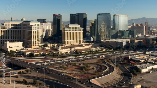 Zoom out, panning shot of the Las Vegas skyline and freeway transition from day to night.