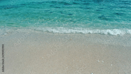 Emerald green water. Beautiful background transparent surface wave  sand on clean beach. Royalty high-quality free stock photo image of clean surface seawater  waves on the beach with sand in sunshine