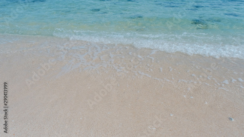 Beautiful background transparent surface wave  sand on clean seaside beach. Royalty high-quality free stock video footage of clean surface seawater  waves on the beach with sand and sunshine in summer