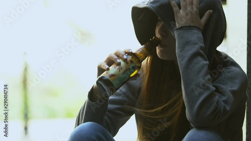 Sad teenager taking beer bottle from female hand, bad street influence addiction