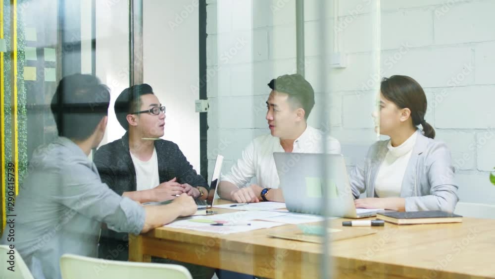 group of young asian entrepreneurs meeting in office discussing business plan group of young asian entrepreneurs meeting in office discussing business plan