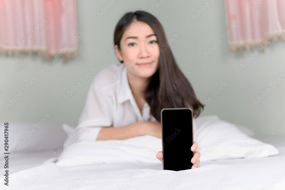 Asian girl use smartphone on bed. Focus smartphone concept. Asian girl use smartphone on bed. Focus smartphone concept.