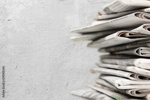 Pile of newspapers on white background