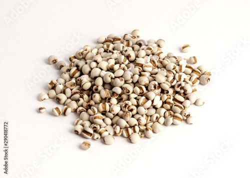 dried pearl barley on white background..