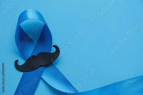 Light blue ribbon with mustache on blue background , Prostate Cancer Awareness, International Men's Day, Movember Men health awareness, November Blue photo