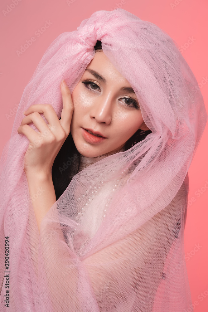 Portrait of beautiful asian woman bride in pink dress. Thai model posing in studio just married wedding concept. Portrait of beautiful asian woman bride in pink dress. Thai model posing in studio just married wedding concept.