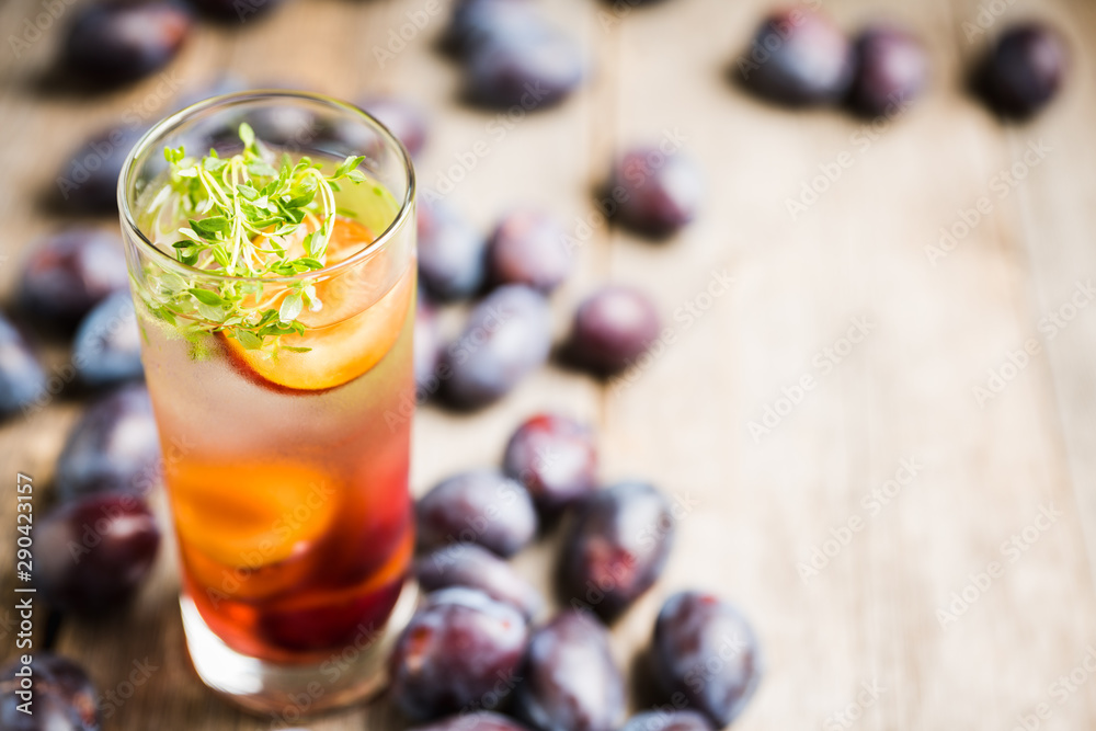 Cocktail with plums and thyme on the rustic background. Selective focus. Shallow depth of field. Cocktail with plums and thyme on the rustic background. Selective focus. Shallow depth of field.
