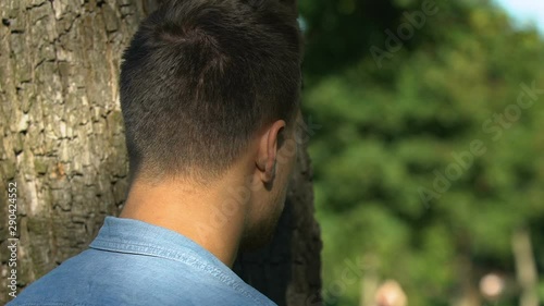 Young man secretly spying his girlfriend meeting with friend, jealousy, betrayal