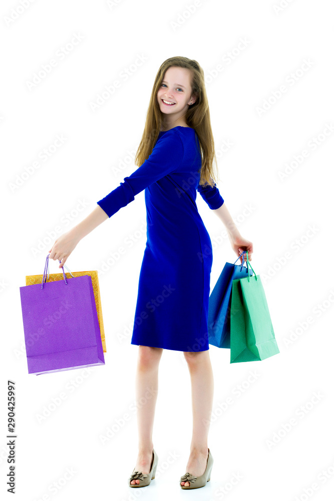 Little girl with multi-colored bags in their hands. Little girl with multi-colored bags in their hands.