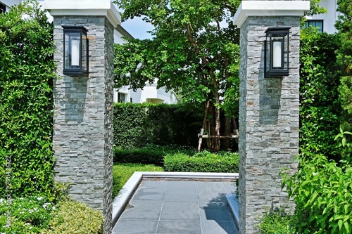 Two brick columns with lights of the walkway to the garden