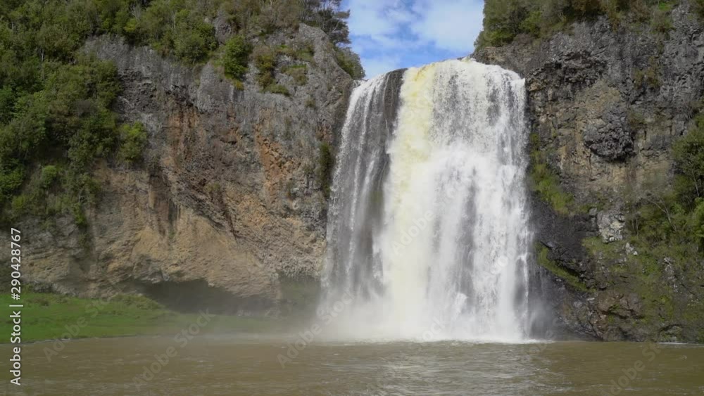 Slow Motion Waterfall falling into rock pool on volcano side while on hiking path in New Zealand Slow Motion Waterfall falling into rock pool on volcano side while on hiking path in New Zealand