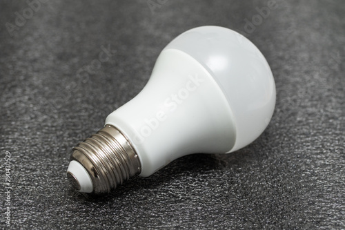 White LED light bulb on a black background. Incandescent lamp. Lighting device.
