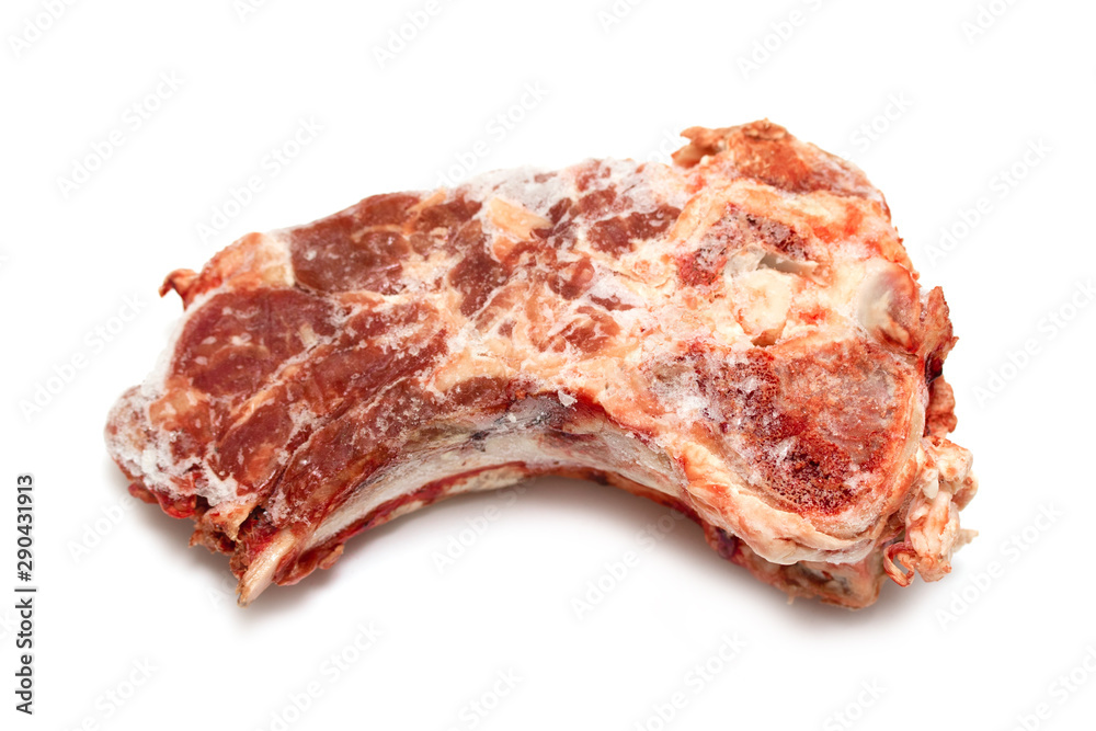 A piece of frozen meat is isolated on a white background. Beef steak on the bone.