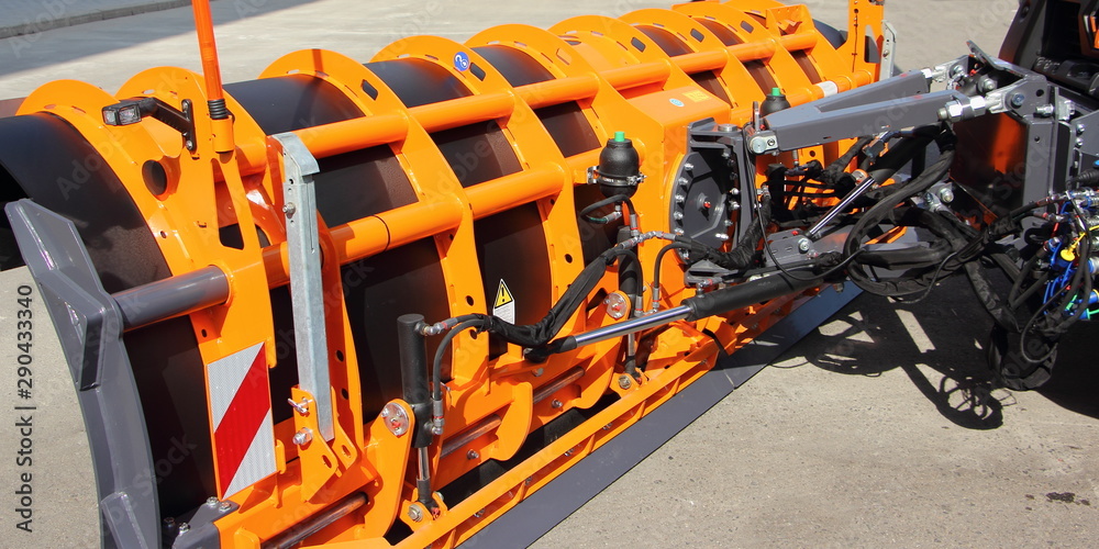 New orange shovel snow plow blade truck with mechanism closeup, modern municipal machinery