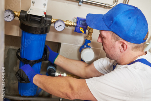 Plumber work. Installing water filter into system