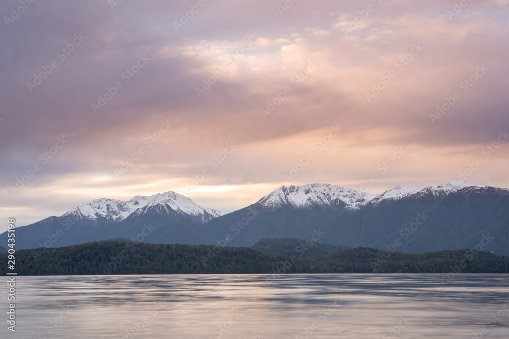 Pink skies at sunset by the Southern alps glacial lake
