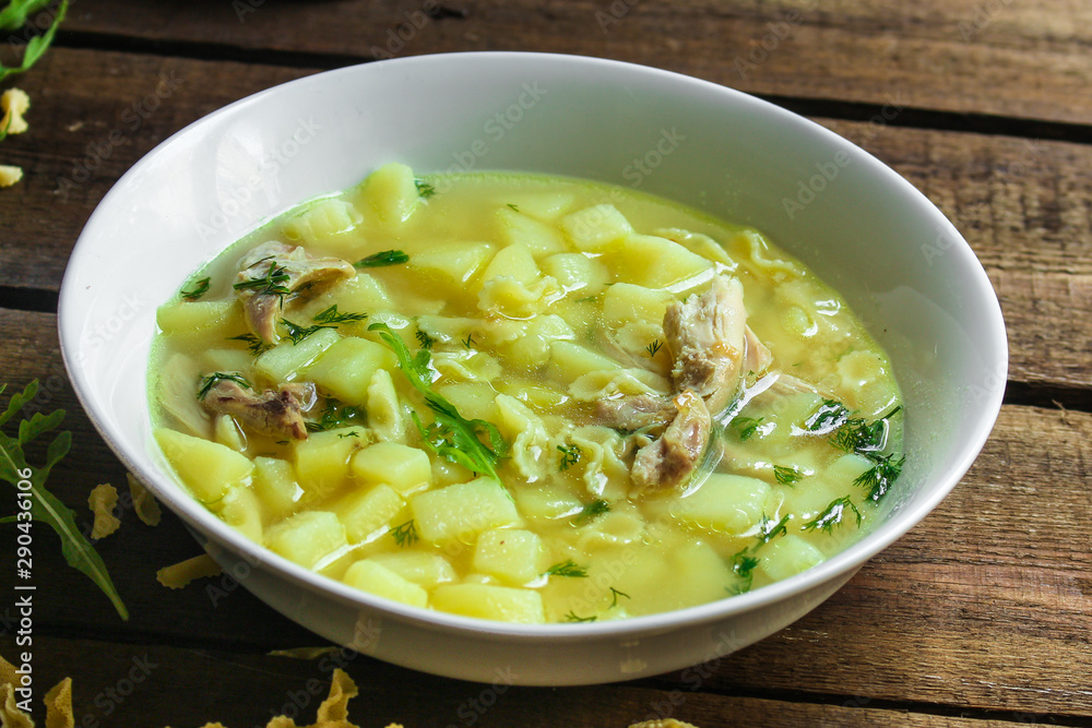 chicken soup farfalle - first course with pasta and vegetables, menu concept. food background. copy space chicken soup farfalle - first course with pasta and vegetables, menu concept. food background. copy space