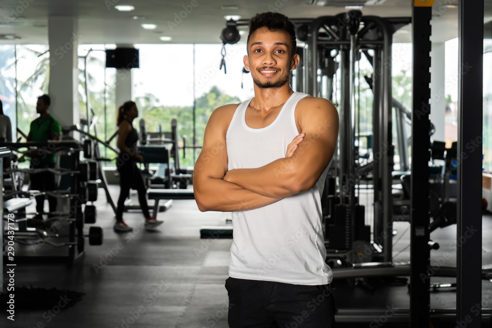 Fit man standing and relax after the training session in gym,Concept healthy and lifestyle,Male taking a break after exercise and workout Fit man standing and relax after the training session in gym,Concept healthy and lifestyle,Male taking a break after exercise and workout