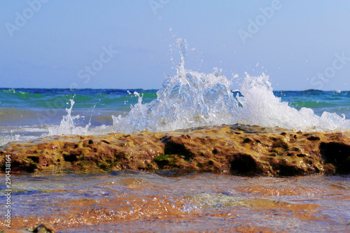 wave splashing on stones on beach