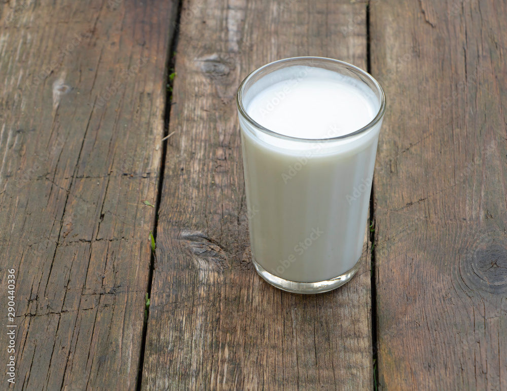 A cup of kefir on wooden background A cup of kefir on wooden background