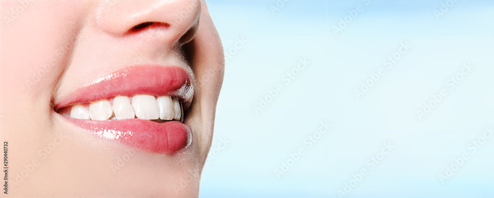 Obraz premium Smiling woman mouth with great white teeth on a blue background