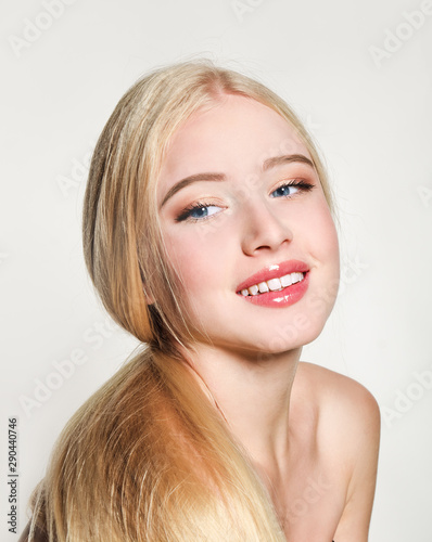 Portrait of beautiful blonde young woman face.  Spa model girl with fresh clean skin isolated on a white background