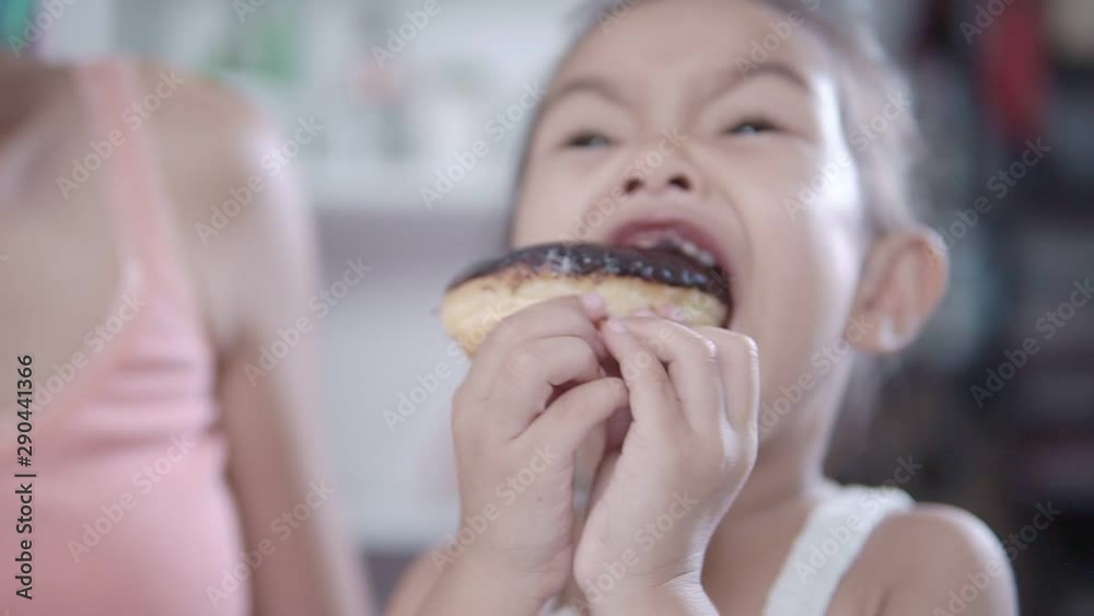 Slow motion clips,A little girl eating chocolate donuts. Slow motion clips,A little girl eating chocolate donuts.