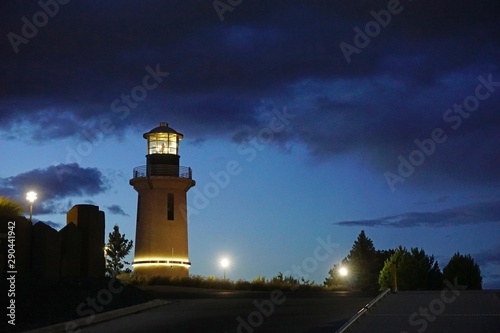 Lighthouse at night with cloudy sky