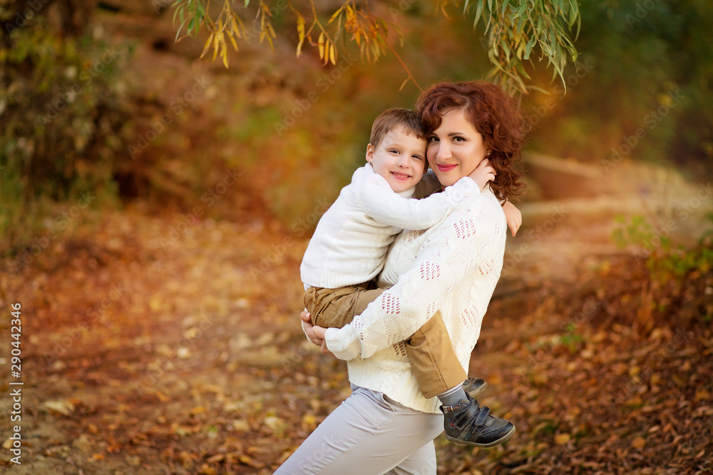 Happy family mother and son have fun in the park for a walk and hug each other. Happy family mother and son have fun in the park for a walk and hug each other.