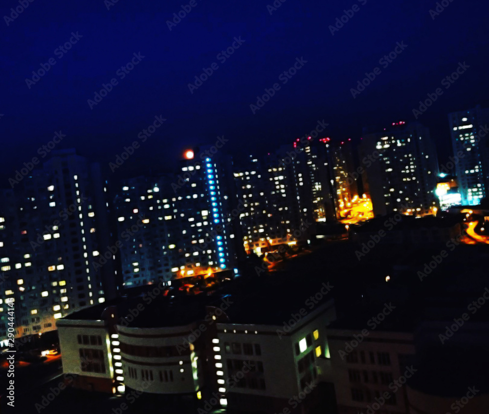 Night time big city view with lightin windows.