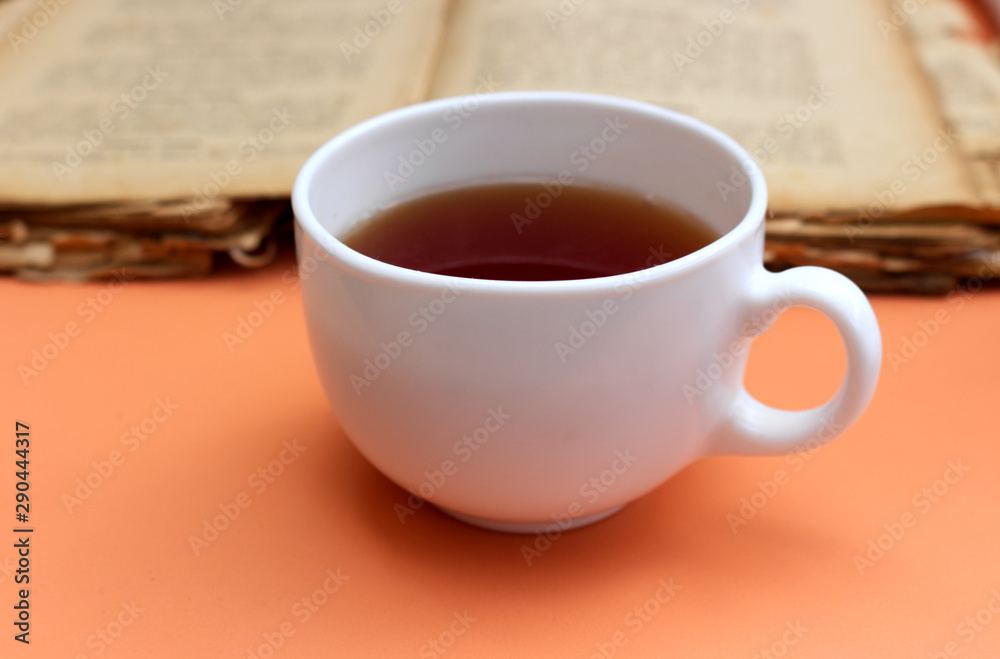 Autumn breakfast in garden. Cup of tea and old book. Autumn breakfast in garden. Cup of tea and old book.