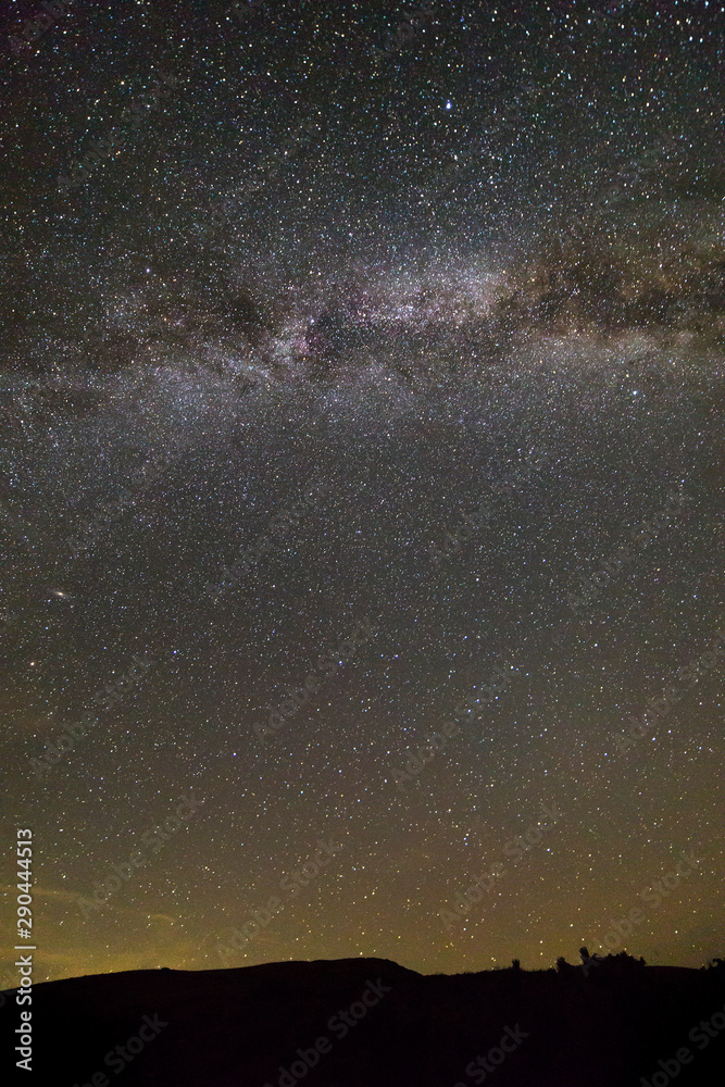 Obraz premium Night landscape of mountains with stars covered sky .