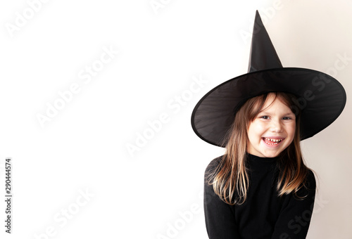 Foto Little blond Caucasian girl in black witch costume