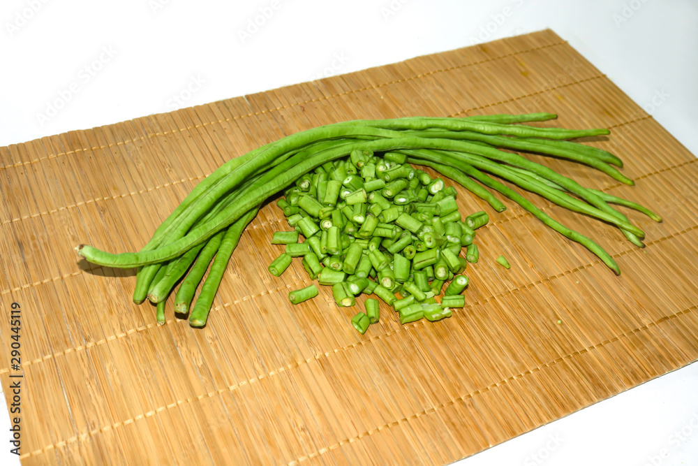 Long hatched beans Placed on a wooden floor in a white background Long hatched beans Placed on a wooden floor in a white background