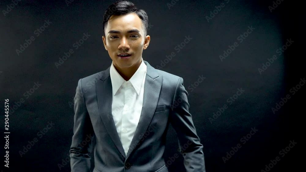 Confident and hansome young businessman in a suit smiles and poses Confident and hansome young businessman in a suit smiles and poses