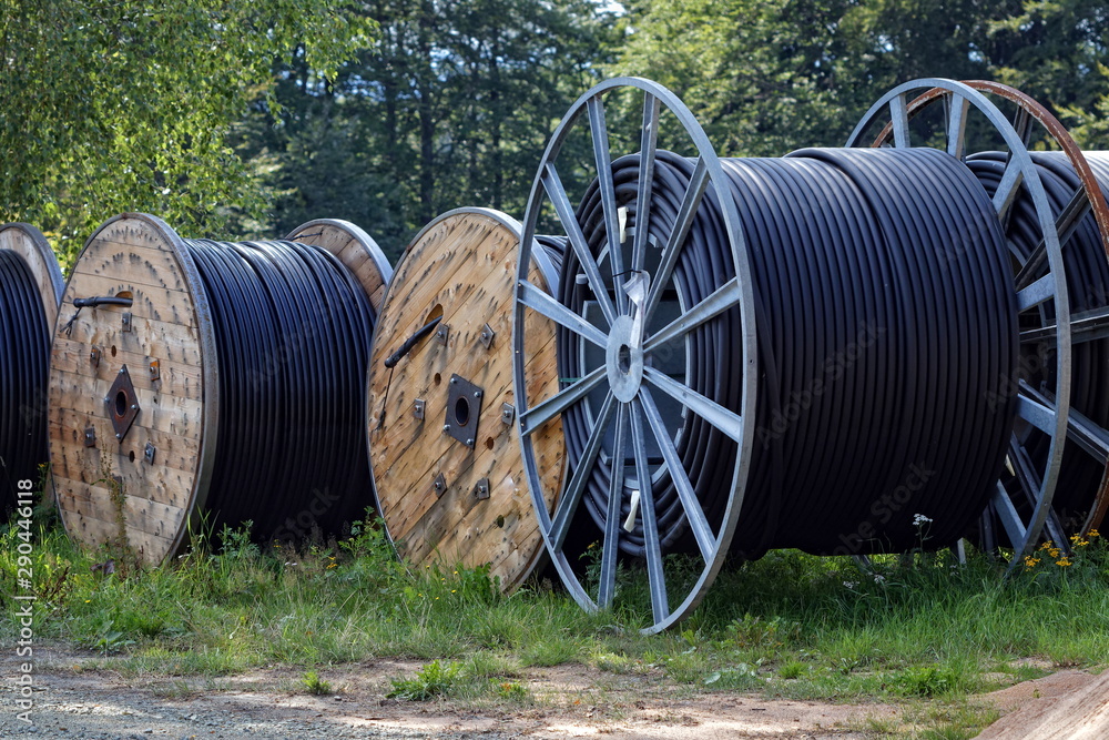 several cable reel standing in the grass several cable reel standing in the grass