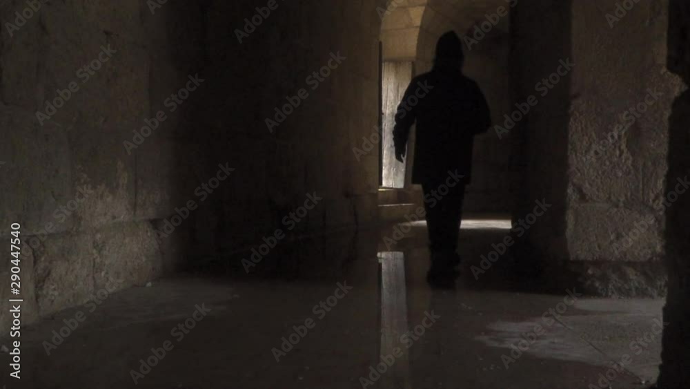 man walking along wet corridor of ancient roman colosseum man walking along wet corridor of ancient roman colosseum