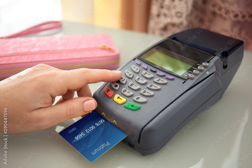 Woman hands holding plastic card and pay pass online terminal Woman hands holding plastic card and pay pass online terminal