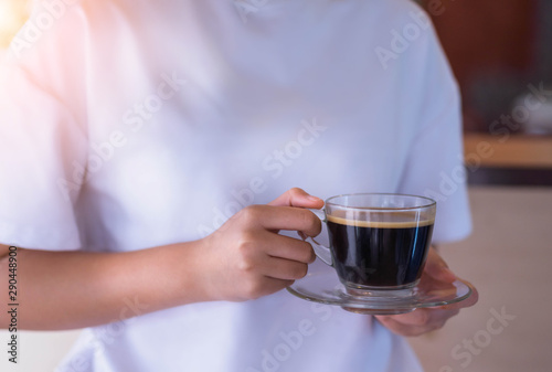 Foto Close up of woman hand holding coffee cup in cafe.