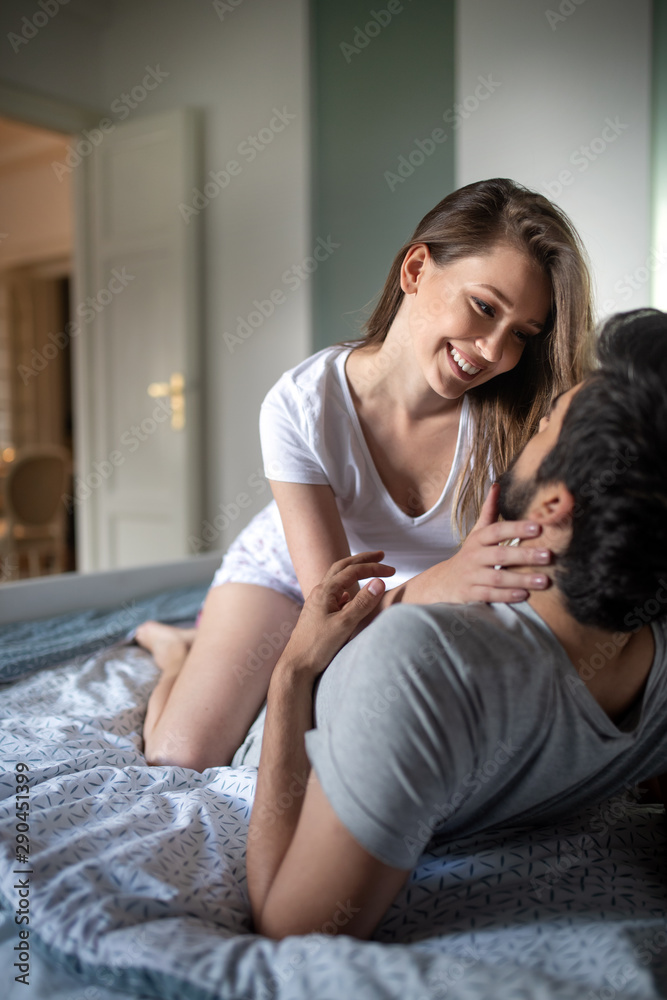 Fototapeta premium Young sensual passionate couple making love in bed