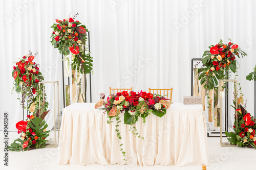 Red decor theme. Beautiful banquet a wedding reception. Interior of a wedding tent decoration ready for guests. Decor flowers.