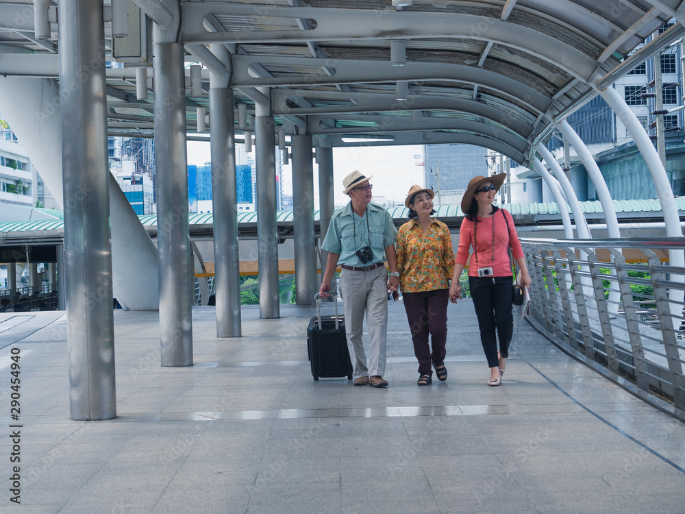 elderly group walking in walk way in city,elder man and woman travel in holiday