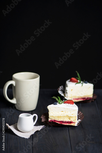 tasty cake with white cream and strawberries on a dark background