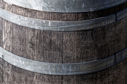 A wooden wine barrel with metal bands or hoops photo