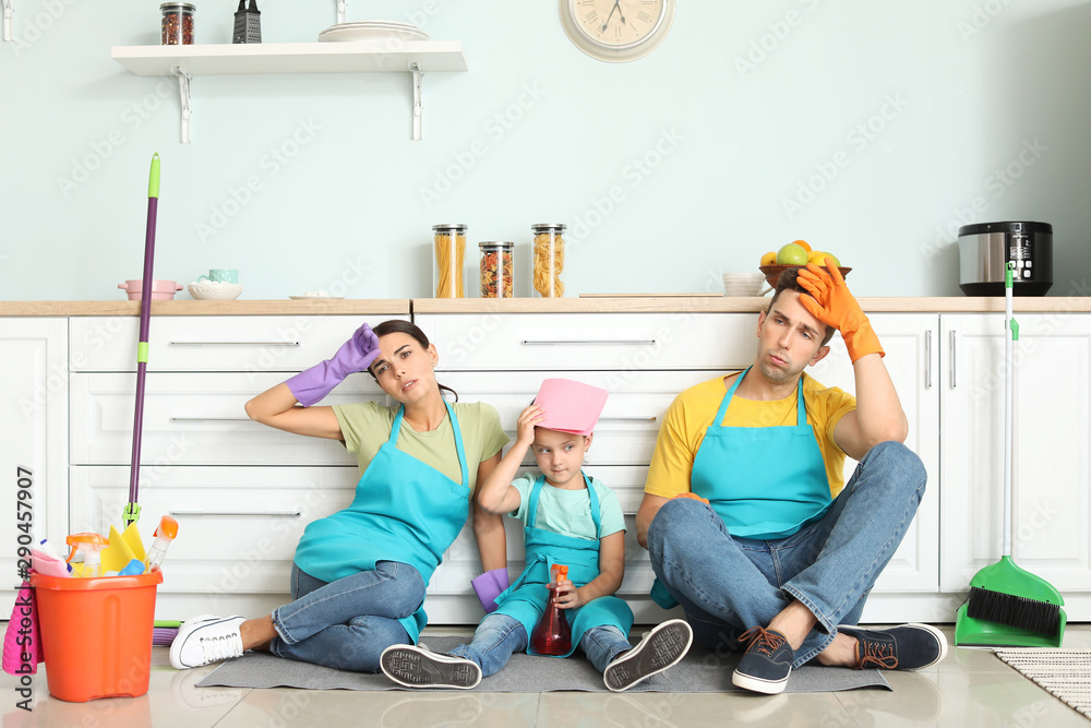 Tired family after cleaning kitchen together