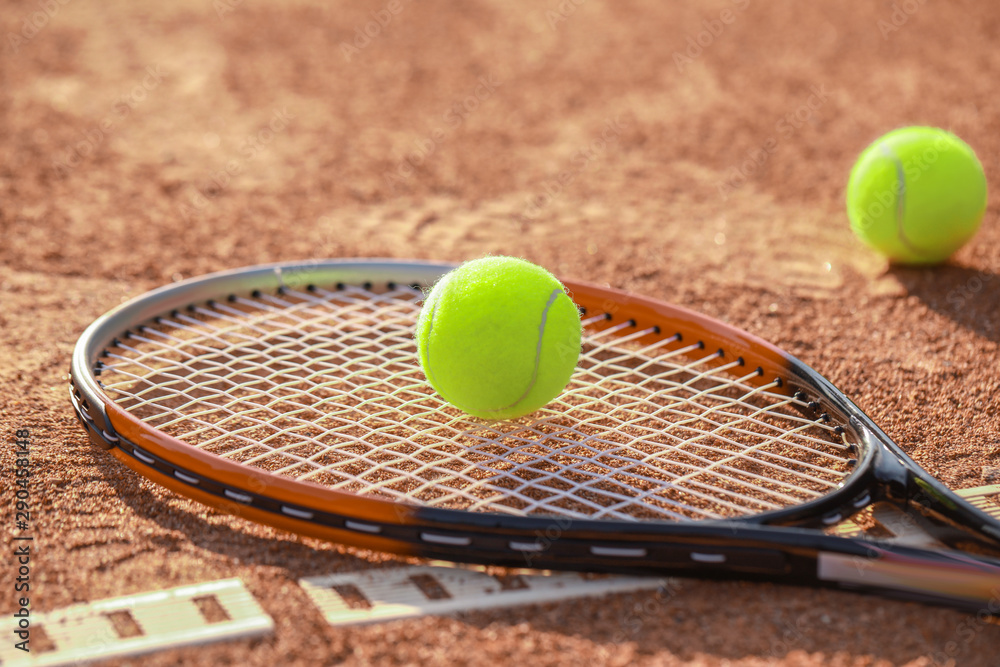 Racket and balls on tennis court