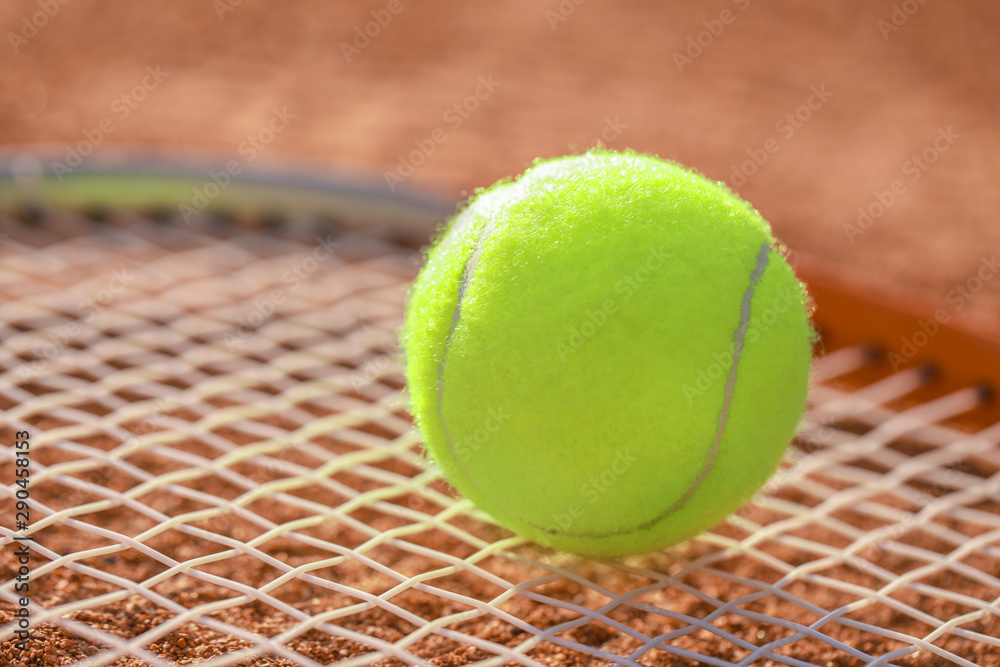 Tennis ball on racket, closeup